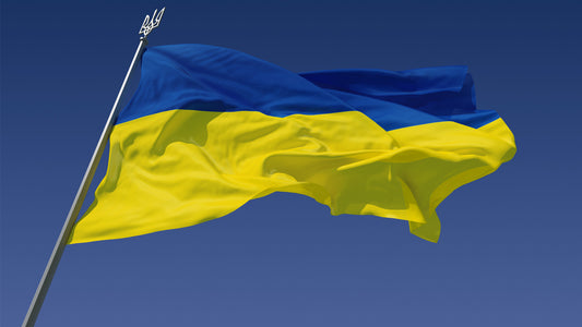 Im Wind wehende Flagge der Ukraine vor blauem Himmel.